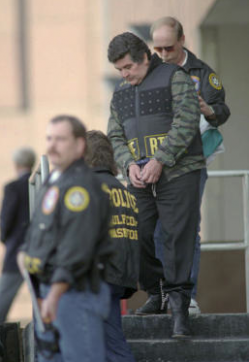 Juan Garcia Abrego, shown being escorted from the federal courthouse in 1996, was sentenced to 11 life terms, largely on the strength of testimony from a Mexican police commander who had been paid $1 million. (Photo by Brett Coomer)